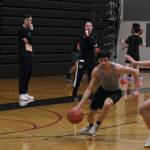 Juneau-Douglas High School: Yadaa.at Kalé boys head coach Robert Casperson, right, and assistant Kaleb Tompkins, left, watch a scrimmage game during the first day of Crimson Bears varsity basketball tryouts Wednesday at the George Houston Gymnasium. (Klas Stolpe / Juneau Empire)