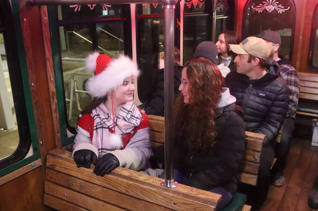 Evelyn Whistler, 11, and her mother, Shannon, ride the Holiday Trolley from the Alaska State Museum to downtown Juneau during Gallery Walk on Friday. (Mark Sabbatini / Juneau Empire)