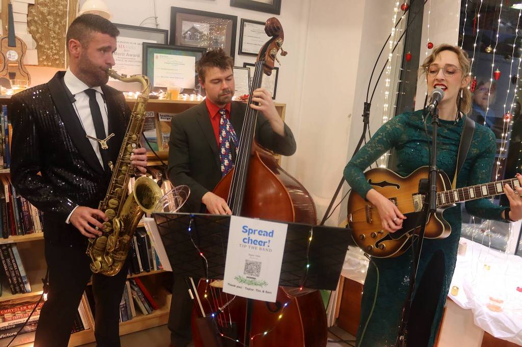 Tim Powers, Sam Roberts and Taylor Vidic perform at Northwind Architects during Gallery Walk on Friday. (Mark Sabbatini / Juneau Empire)
