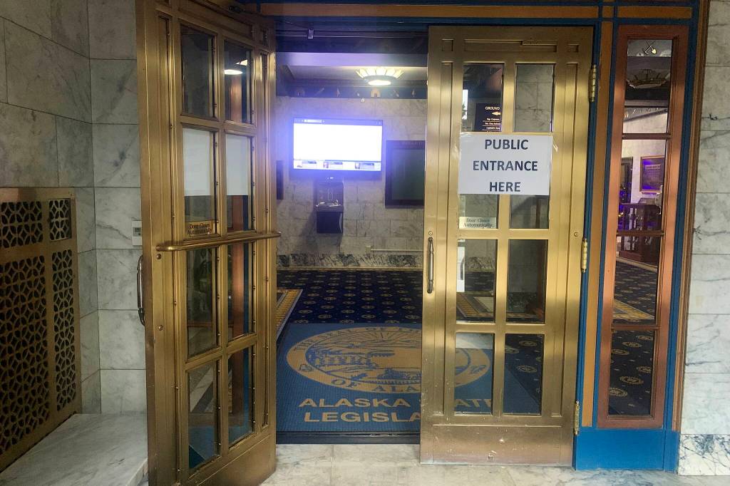 A sign at the front entrance of the Alaska State Capitol indicates the door for members of the public. The Legislative Council is scheduled to consider new rules Thursday that will subject all such visitors to security screenings similar to those at airports. (Mark Sabbatini / Juneau Empire)