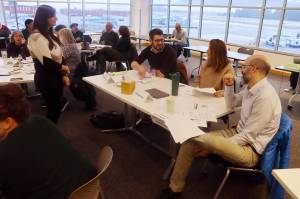 Juneau Assembly members and city administrative leaders participate in group discussions during the Assemblys annual retreat in the main conference room at Juneau International Airport on Saturday. (Mark Sabbatini / Juneau Empire)