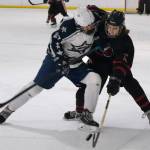 Soldotnas Keegan Myrick and Juneau-Douglas High School: Yadaa.at Kalé sophomore Caden Morris battle for a puck during Fridays 4-3 Crimson Bears loss to the visiting Stars at Treadwell Ice Arena. (Klas Stolpe / Juneau Empire)