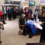 Bob Urata (left), a doctor credited with helping establish and grow hospice care in Juneau, and Mandy Mallott, daughter of the one of the first patients in Bartlett Regional Hospitals Home Health and Hospice program, address attendees at a Light Up a Life community celebration Friday evening at the hospital. (Mark Sabbatini / Juneau Empire)