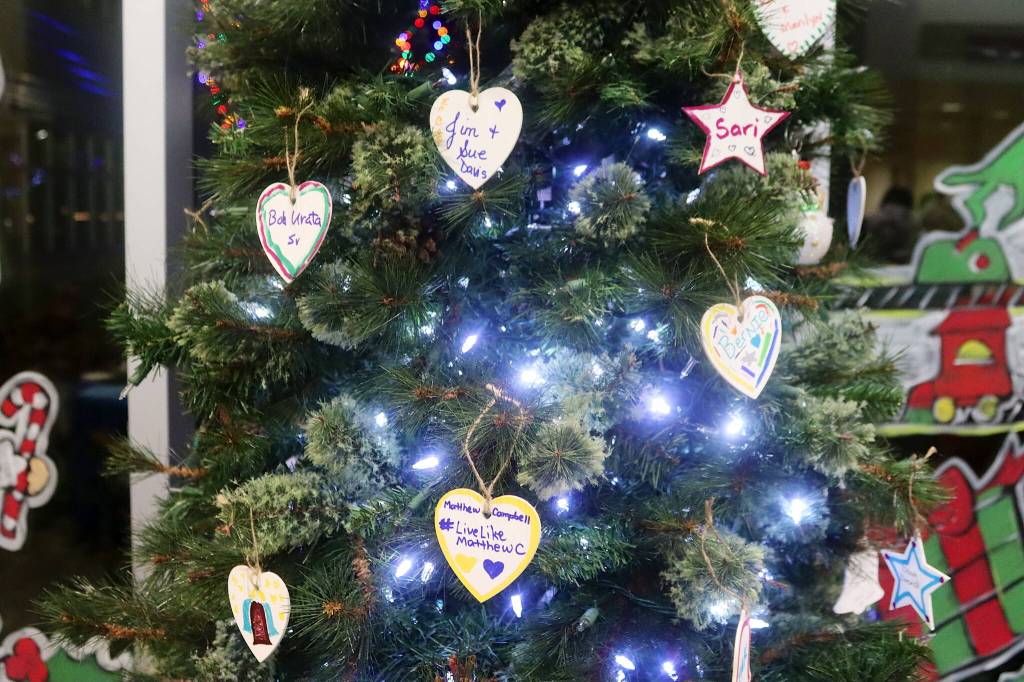 Hand-decorated memorial ornaments hang on a Christmas tree during a Light Up a Life community celebration hosted by the Bartlett Regional Hospitals Home Health and Hospice program Friday evening. (Mark Sabbatini / Juneau Empire)