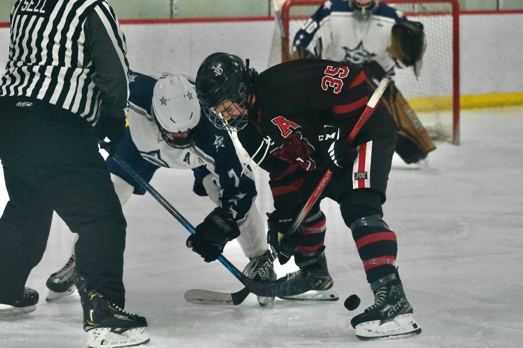 Juneau-Douglas High School: Yadaa.at Kalé senior Dylan Sowa faces off against Soldotnas Noah Crabtree (7) during the Crimson Bears 2-0 win over the Stars on Saturday at Treadwell Ice Arena. (Klas Stolpe / Juneau Empire)