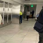 Travelers using the all-gender restroom at Seattle–Tacoma International Airport on Dec. 3. (Laurie Craig / Juneau Empire)