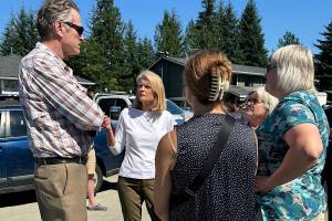 Gov. Mike Dunleavy (left) talks with U.S. Sen. Lisa Murkowski and local leaders during an Aug. 7 visit to a Mendenhall Valley neighborhood hit by record flooding. (Photo provided by U.S. Sen. Lisa Murkowskis office)