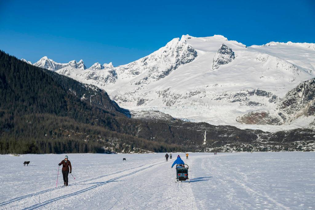 Cross country skiers trek along groomed trails on Mendenhall Lake with views of the Mendenhall Glacier, outside of Juneau, Alaska, March 3, 2024. The states capital, a popular cruise port in summer, becomes a bargain-seekers base for skiing, skating, hiking and glacier-gazing in the winter off-season. (Christopher S. Miller/The New York Times)