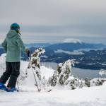 A skier takes in the sweeping view from a ridge at Eaglecrest Ski Area, which has three lifts and access to 640 acres, in Juneau, Alaska, March 10, 2024. The states capital, a popular cruise port in summer, becomes a bargain-seekers base for skiing, skating, hiking and glacier-gazing in the winter off-season. (Christopher S. Miller/The New York Times)