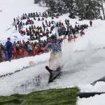 Elias Lowell, 15, balances his way to the end of the pond during the annual Slush Cup at Eaglecrest Ski Area on April 7, the last day of what officials called an up-and-down season. (Mark Sabbatini / Juneau Empire file photo)