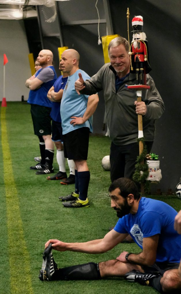 Nutcrackers coach Marty McKeown holds the teams noisemaker during the opening night of the Holiday Cup soccer tournament at the Dimond Park Field House on Wednesday. The 32nd annual holiday tournament runs through Dec. 31. McKeown is a sponsor. (Klas Stolpe / Juneau Empire)