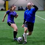 The Wet Bandits Shannon Hendricks and the Nutcrackers Kyle Hebert play a ball during the opening night of the Holiday Cup soccer tournament at the Dimond Park Field House on Wednesday. The 32nd annual holiday tournament runs through Dec. 31. (Klas Stolpe / Juneau Empire)