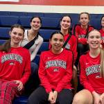 The Juneau-Douglas High School: Yadaa.at Kalé Crimson Bears girls basketball team pose in the bleachers at Durango High School in Las Vegas during the Tarkanian Classic Tournament. (Photo courtesy JDHS Crimson Bears)