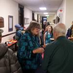 State Rep. Sara Hannan talks with visitors outside her office at the Alaska State Capitol during the annual holiday open house hosted by Juneaus legislative delegation on Friday. (Mark Sabbatini / Juneau Empire)