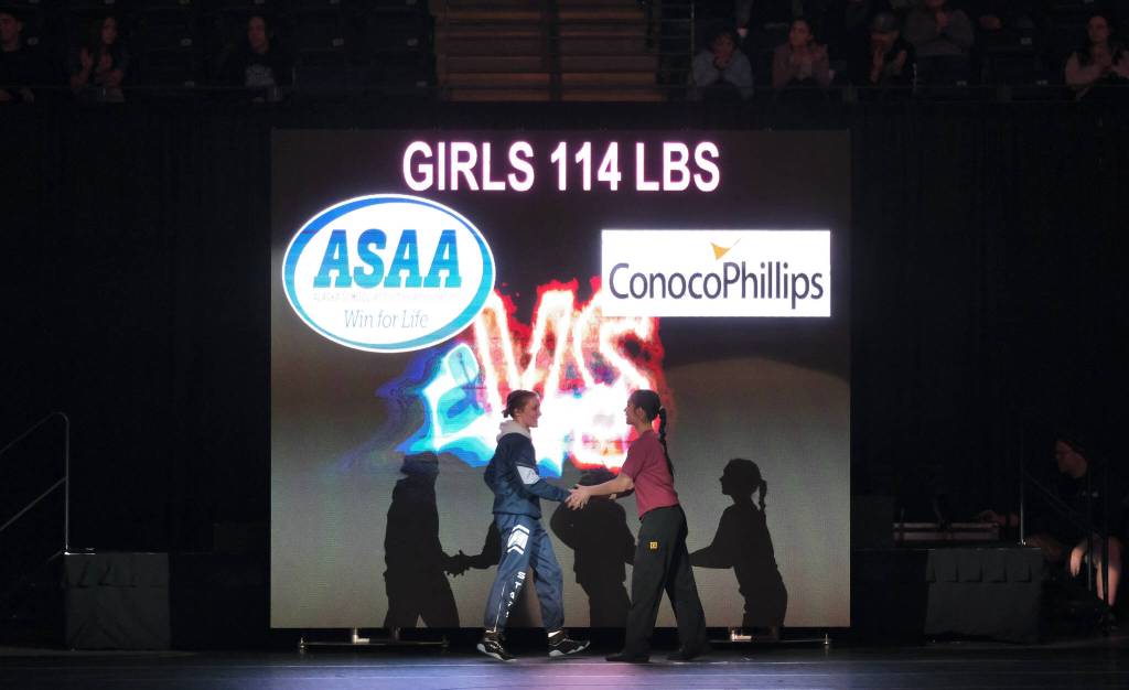Soldotnas Mia Hannevold and Mt. Edgecumbes Nevaeh George shake hands before their girls 114-pound title match during the 2024 ASAA/First National Bank Alaska Wrestling State Championships on Saturday at Anchorages Alaska Airlines Center. (Klas Stolpe / Juneau Empire)