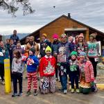 Participants in the 2024 Solstice Sweater Shuffle pose for a photo at Lena Beach campground. (Photo courtesy race directors)