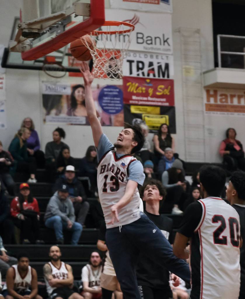 2016 Juneau-Douglas High School: Yadaa.at Kalé graduate Kaleb Tompkins scores against the Crimson Bears during alumni games Monday at the George Houston Gymnasium. (Klas Stolpe / Juneau Empire)