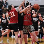 2021 Juneau-Douglas High School: Yadaa.at Kalé graduate Jenae Pusich (31) and 2003 graduate Danielle Larson (33) battle for a rebound against the Crimson Bears Sadie Lockhart (back), Lydia Goins and Athena Warr during alumni games Monday at the George Houston Gymnasium. (Klas Stolpe / Juneau Empire)