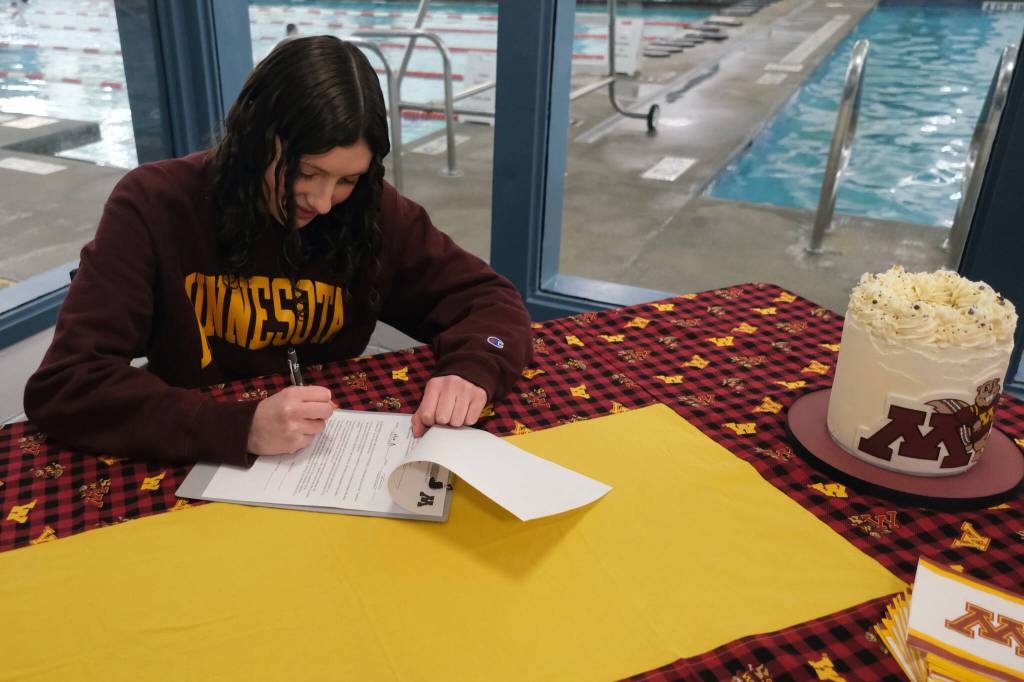 Juneau-Douglas High School: Yadaa.at Kalé senior Emma Fellman signs a national letter of intent in November 2024 at Augustus Brown Pool to attend and swim for the University of Minnesota. (Klas Stolpe / Juneau Empire file photo)