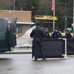 Officials prepare to move Ashley Rae Johnston from the street where she was fatally shot by police on Wednesday near the Mendenhall Valley Breeze In. (Mark Sabbatini / Juneau Empire)