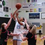 Chugiak sophomore Natalie Farr (23) floats a shot over Kenai junior Ellsi Miller (33), junior Mckenzie Spence (23) and freshman Hallie Songer (34) during the Mustangs 43-34 win over the Cardinals in the opening game of the George Houston Capital City Classic Friday in Juneau. (Klas Stolpe / Juneau Empire)