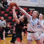 Chugiak freshman Kaitlyn Farr (3) checks Kenai freshman Bryleigh Williams (22) during the Mustangs 43-34 win over the Cardinals in the opening game of the George Houston Capital City Classic Friday in Juneau. (Klas Stolpe / Juneau Empire)
