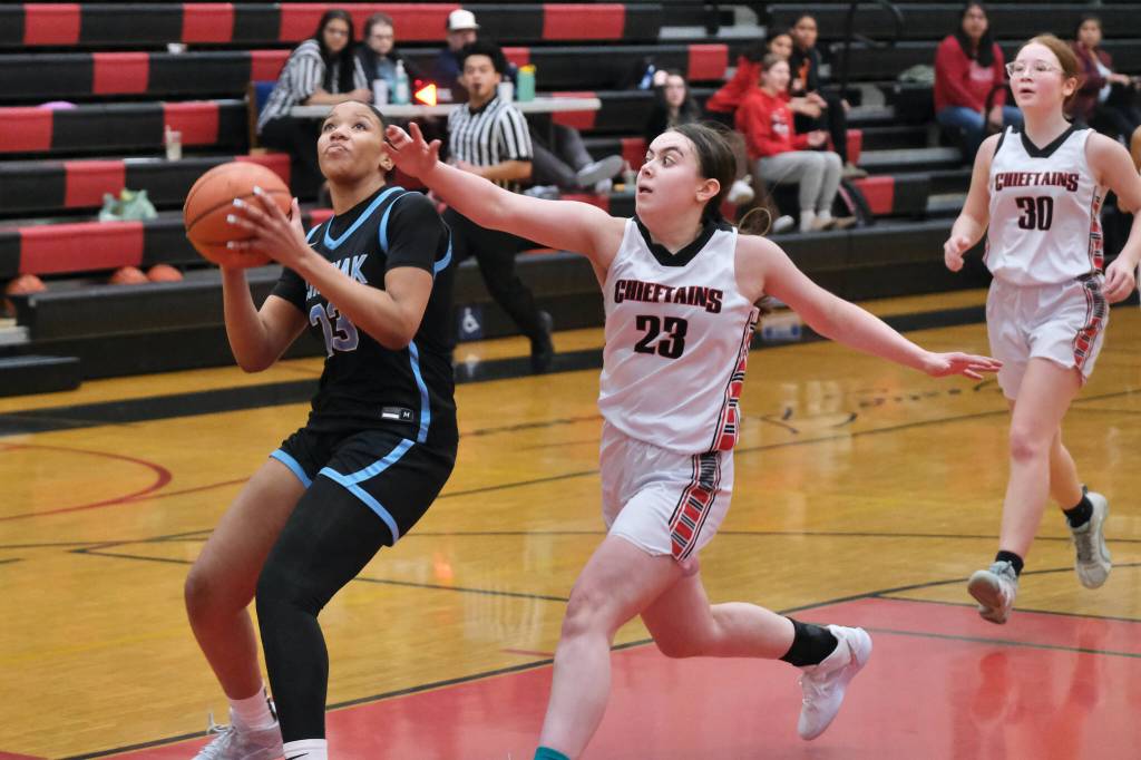 Chugiak sophomore Natalie Horn (23) goes up for a layup ahead of Klawock senior Lea Armour (23) and eighth grader Alli Demmert (30) in the Mustangs 45-25 win over the Chieftains during Saturday action at the George Houston Capital City Classic in Juneau. (Klas Stolpe / Juneau Empire)