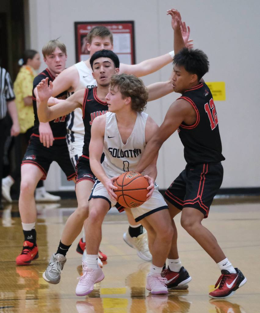 Juneau-Douglas High School: Yadaa.at Kalé juniors Damian Efergan and Joren Gasga (12) pressure Soldotna junior Owen Buckbee (1) in the Crimson Bears 62-60 overtime loss to the Stars during Saturday action at the George Houston Capital City Classic in Juneau. (Klas Stolpe / Juneau Empire)