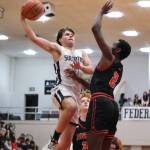 Soldotna senior Easton Hawkins (0) challenges Juneau-Douglas High School: Yadaa.at Kalé senior Ahmir Parker (2) in the Stars 62-60 overtime win over the Crimson Bears during Saturday action at the George Houston Capital City Classic in Juneau. (Klas Stolpe / Juneau Empire)