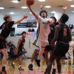 Soldotna senior Izaiah Gilbert (21) scores against Juneau-Douglas High School: Yadaa.at Kalé defenders in the Stars 62-60 overtime win over the Crimson Bears during Saturday action at the George Houston Capital City Classic in Juneau. (Klas Stolpe / Juneau Empire)