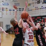 Kenai junior Ellsi Miller (33) attempts a shot against Klawock seniors Kaiya Marvin (12) and Lea Armour in the Cardinals 45-27 win over the Chieftains during Sunday action at the George Houston Capital City Classic Friday in Juneau. (Klas Stolpe / Juneau Empire)