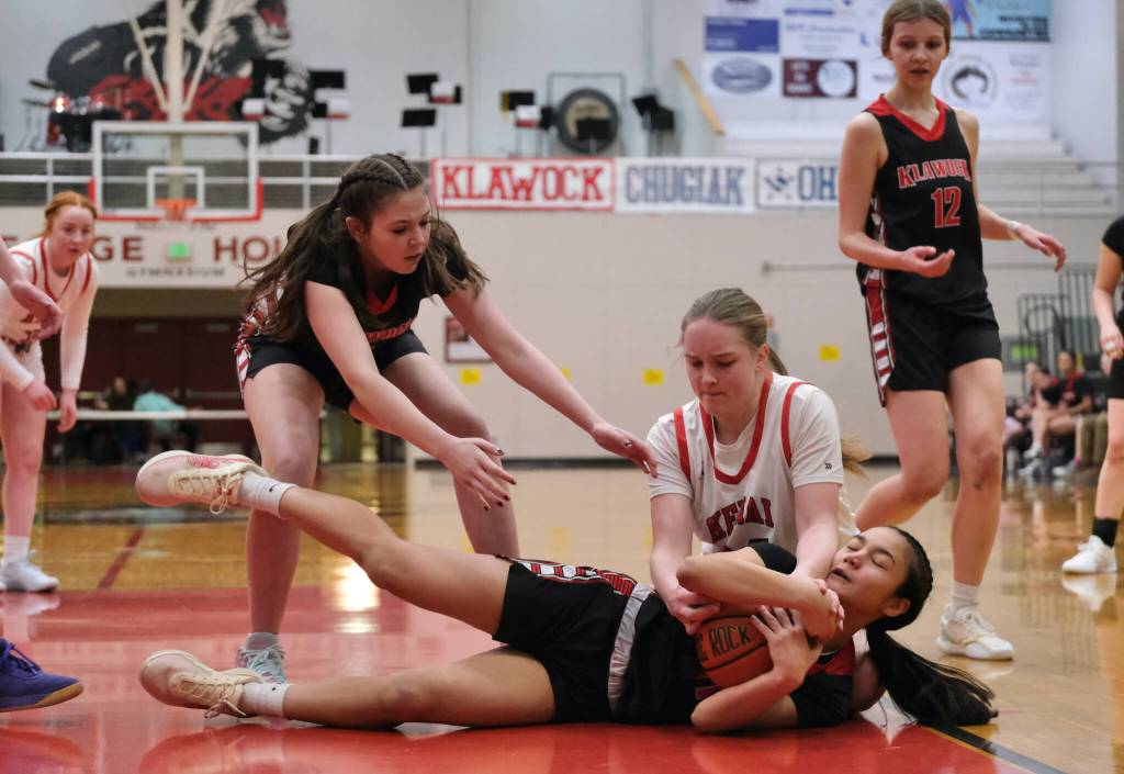 Kenai freshman Hallie Songer and Klawock freshman AnaRose Peratrovich, at left, and eighth grader Jayla Edenshaw go for a loose ball in the Cardinals 45-27 win over the Chieftains during Sunday action at the George Houston Capital City Classic Friday in Juneau. (Klas Stolpe / Juneau Empire)