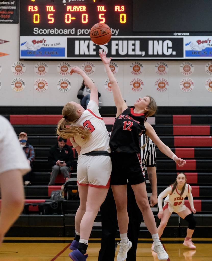 Kenai junior Ellsi Miller (33) and Klawock senior Kaiya Marvin (12) jump center to open the final day of the George Houston Capital City Classic on Sunday in Juneau. (Klas Stolpe / Juneau Empire)