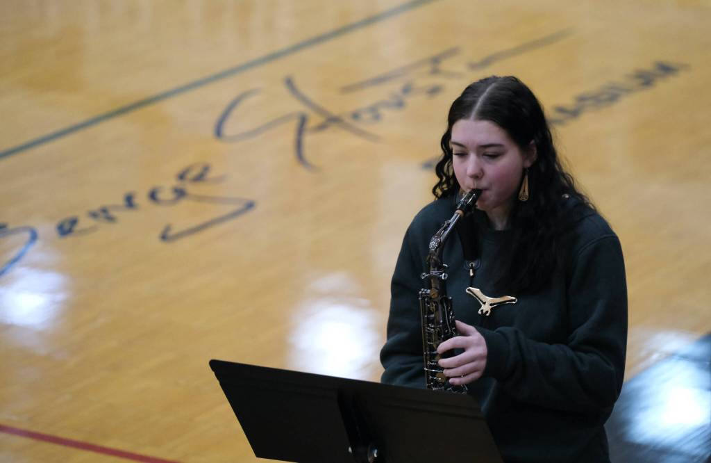 Juneau-Douglas High School: Yadaa.at Kalé senior Marzena Whitmore plays the national anthem to open Sundays action in the George Houston Capital City Classic at the GH Gymnasium. (Klas Stolpe / Juneau Empire)