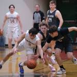 Soldotna junior Owen Buckbee (1) and senior Easton Hawkins (0) go for a loose ball with Cordova junior Blake Bailey (2)during the Stars 56-52 overtime win over the Wolverines during Sunday action at the George Houston Capital City Classic in Juneau. (Klas Stolpe / Juneau Empire)