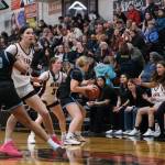 Juneau-Douglas High School: Yadaa.at Kalé coach Tanya Nizich directs the defense of senior Kerra Baxter (22) and junior Cambry Lockhart (3) against Chugiak sophomore Natalie Horn (23) and senior Sadie Bell during the Crimson Bears 51-38 win over the Mustangs in the girls championship game at the George Houston Capital City Classic on Sunday in Juneau. (Klas Stolpe / Juneau Empire)