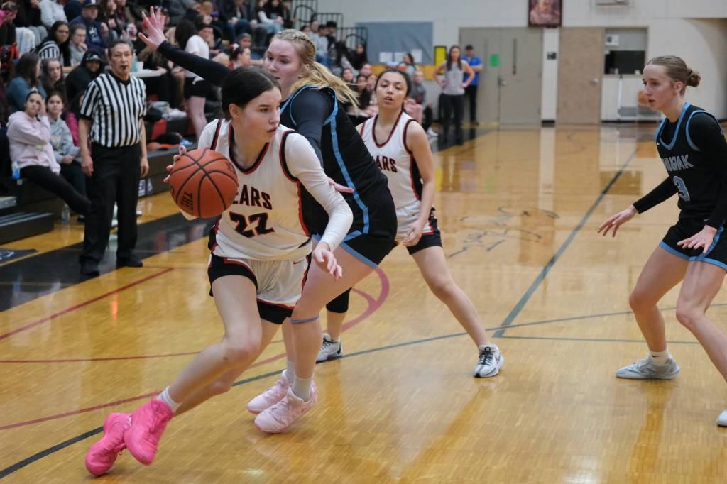 Juneau-Douglas High School: Yadaa.at Kalé senior Kerra Baxter dribbles over a screen by senior Mary Johnson and past Chugiak senior Emily Mullin (34) and freshman Kaitlyn Farr (3) during the Crimson Bears 51-38 win over the Mustangs in the girls championship game at the George Houston Capital City Classic on Sunday in Juneau. (Klas Stolpe / Juneau Empire)