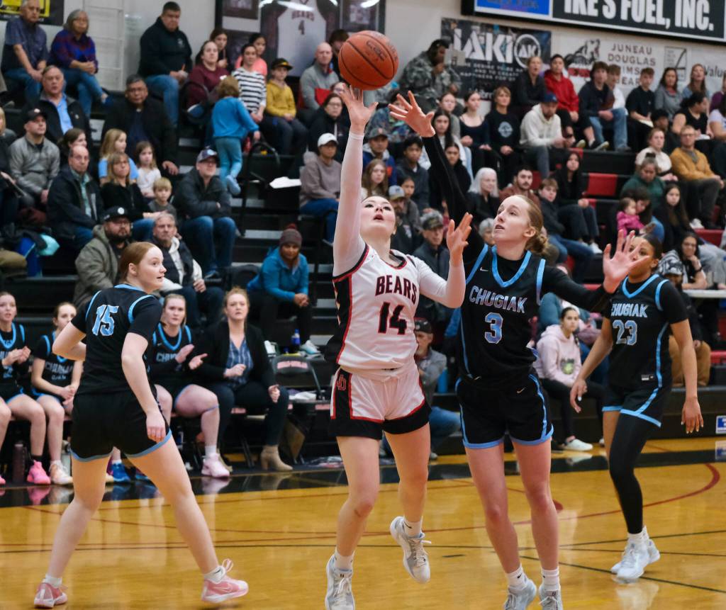 Juneau-Douglas High School: Yadaa.at Kalé sophomore Layla Tokuoka (14) shoots over Chugiak freshman Kaitlyn Farr (3) as senior Emily Desmond (15) and sophomore Natalie Horn (23) look on during the girls championship game at the George Houston Capital City Classic on Sunday in Juneau. (Klas Stolpe / Juneau Empire)
