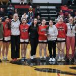 The Juneau-Douglas High School: Yadaa.at Kalé Crimson Bears girls basketball team pose with their championship trophy at the George Houston Capital City Classic on Sunday. (Klas Stolpe / Juneau Empire)