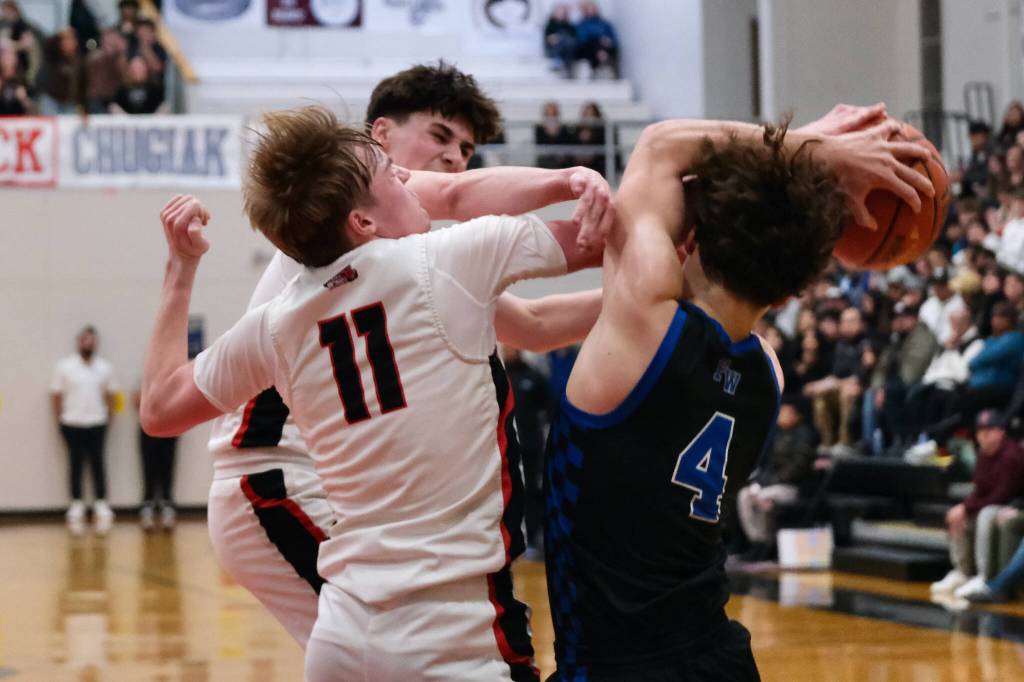 Juneau-Douglas High School: Yadaa.at Kalé senior Ben Sikes (11) and junior Brandon Casperson battle for a rebound with Federal Way senior Brayden McVey (4) during the Crimson Bears 61-48 loss to the Eagles in the boys championship game at the George Houston Capital City Classic on Sunday in Juneau. (Klas Stolpe / Juneau Empire)