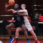 Juneau-Douglas High School: Yadaa.at Kalé senior Ben Sikes (11) defends Federal Way senior Saxon Niles (15) during the Crimson Bears 61-48 loss to the Eagles in the boys championship game at the George Houston Capital City Classic on Sunday in Juneau. (Klas Stolpe / Juneau Empire)