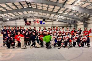 Juneau-Douglas High School: Yadaa.at Kalé alumni hockey players pose on the Treadwell Ice Arena sheet on Dec. 26. (Photo courtesy JDHS hockey)