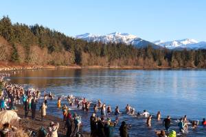 Hundreds of people plunge into Auke Rec on New Years Day in Juneau. (Jasz Garrett / Juneau Empire)