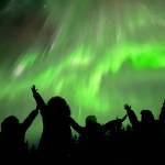 People watch the northern lights near Skaters Cabin on New Years Eve. (Photo by John David)
