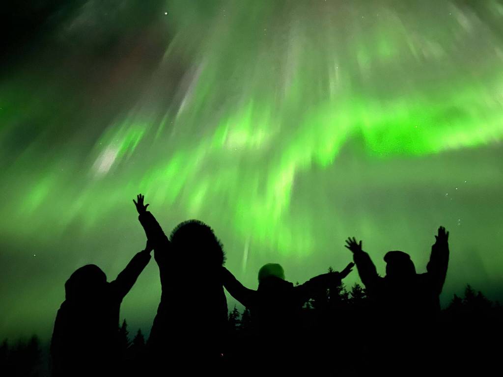 People watch the northern lights near Skaters Cabin on New Years Eve. (Photo by John David)