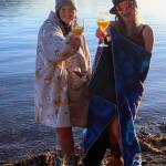 Jillian Schuyler and Khrystl Brouillette celebrate after the Polar Bear Dip on New Years Day 2025. (Jasz Garrett / Juneau Empire)