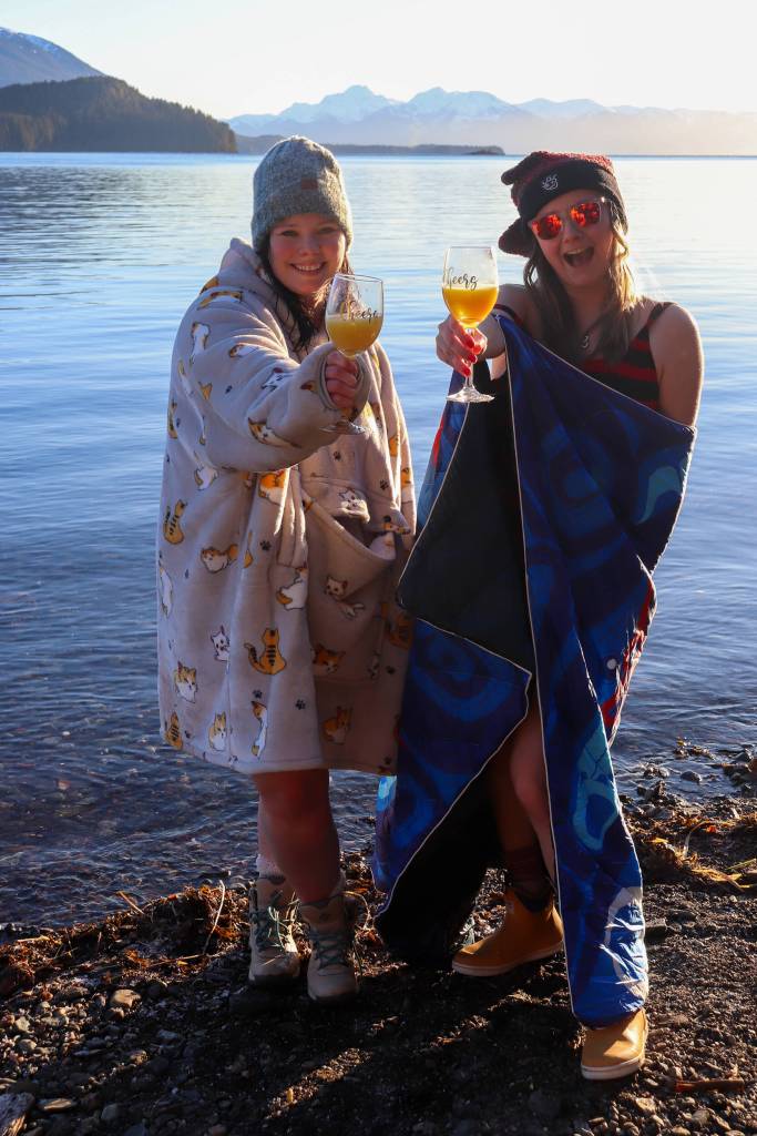 Jillian Schuyler and Khrystl Brouillette celebrate after the Polar Bear Dip on New Years Day 2025. (Jasz Garrett / Juneau Empire)