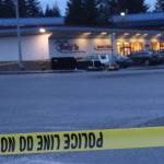 A Juneau Police Department officer monitors the perimeter of a marked-off area next to the Mendenhall Valley Breeze In after a women carrying a hatchet was fatally shot by police officers on Christmas morning. (Mark Sabbatini / Juneau Empire file photo)