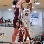 Ketchikan senior Marcus Stockhausen (34) defends a shot by Juneau-Douglas High School: Yadaa.at Kalé junior Tyler Frisby (21) during the Kings 52-48 win over the Crimson Bears on Friday at the George Houston Gymnasium in Juneau. (Klas Stolpe / Juneau Empire)