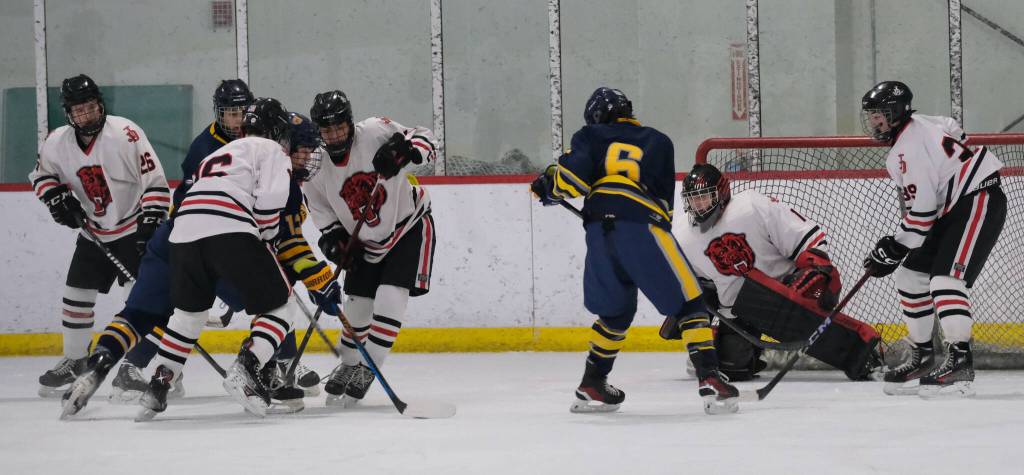 Juneau-Douglas High School: Yadaa.at Kalé senior goalie Caleb Friend (1) protects the goal as JDHS and Bartlett players battle for a puck during the Crimson Bears 10-6 win over the Golden Bears on Saturday at Treadwell Ice Arena. (Klas Stolpe / Juneau Empire)